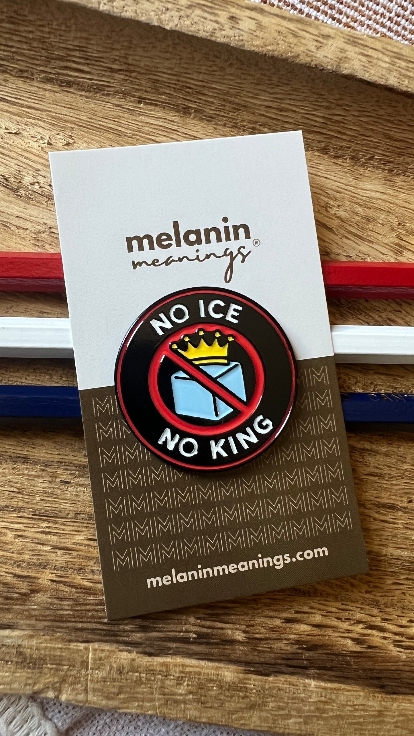 No Ice No King protest enamel pin on a Melanin Meanings backing card styled with red white and blue pencils